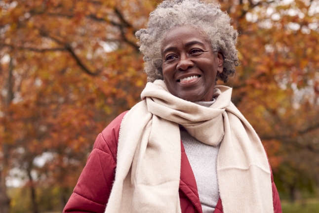 Older woman in a park during the fall